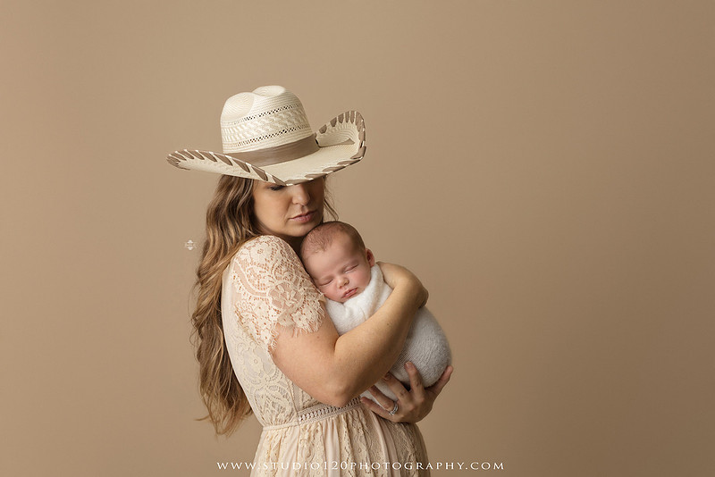 SOTP5913 copyProfessional newborn photography session featuring a sleeping baby boy in rustic western-inspired setups with cowboy hats, neutral wraps, wooden props, greenery, and vintage accents, along with heartfelt family portraits with parents and their dogs at Studio 120 Photography in Ramona, California.