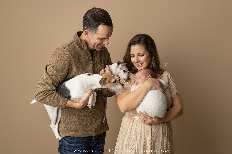 SOTP5913 copyProfessional newborn photography session featuring a sleeping baby boy in rustic western-inspired setups with cowboy hats, neutral wraps, wooden props, greenery, and vintage accents, along with heartfelt family portraits with parents and their dogs at Studio 120 Photography in Ramona, California.