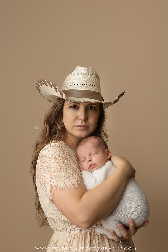 SOTP5913 copyProfessional newborn photography session featuring a sleeping baby boy in rustic western-inspired setups with cowboy hats, neutral wraps, wooden props, greenery, and vintage accents, along with heartfelt family portraits with parents and their dogs at Studio 120 Photography in Ramona, California.