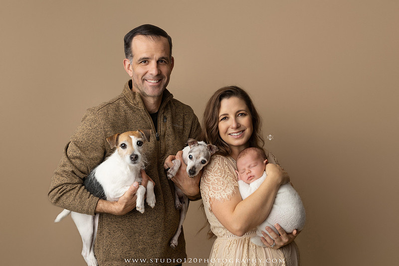 SOTP5913 copyProfessional newborn photography session featuring a sleeping baby boy in rustic western-inspired setups with cowboy hats, neutral wraps, wooden props, greenery, and vintage accents, along with heartfelt family portraits with parents and their dogs at Studio 120 Photography in Ramona, California.