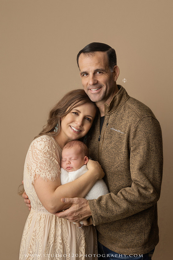 SOTP5913 copyProfessional newborn photography session featuring a sleeping baby boy in rustic western-inspired setups with cowboy hats, neutral wraps, wooden props, greenery, and vintage accents, along with heartfelt family portraits with parents and their dogs at Studio 120 Photography in Ramona, California.