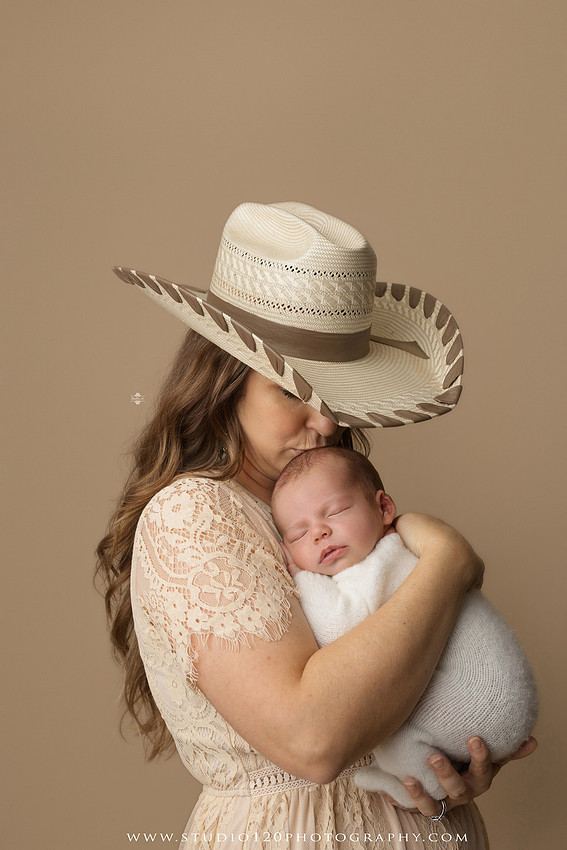 SOTP5913 copyProfessional newborn photography session featuring a sleeping baby boy in rustic western-inspired setups with cowboy hats, neutral wraps, wooden props, greenery, and vintage accents, along with heartfelt family portraits with parents and their dogs at Studio 120 Photography in Ramona, California.