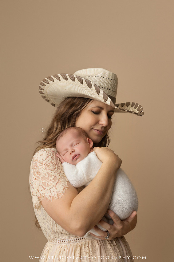 SOTP5913 copyProfessional newborn photography session featuring a sleeping baby boy in rustic western-inspired setups with cowboy hats, neutral wraps, wooden props, greenery, and vintage accents, along with heartfelt family portraits with parents and their dogs at Studio 120 Photography in Ramona, California.