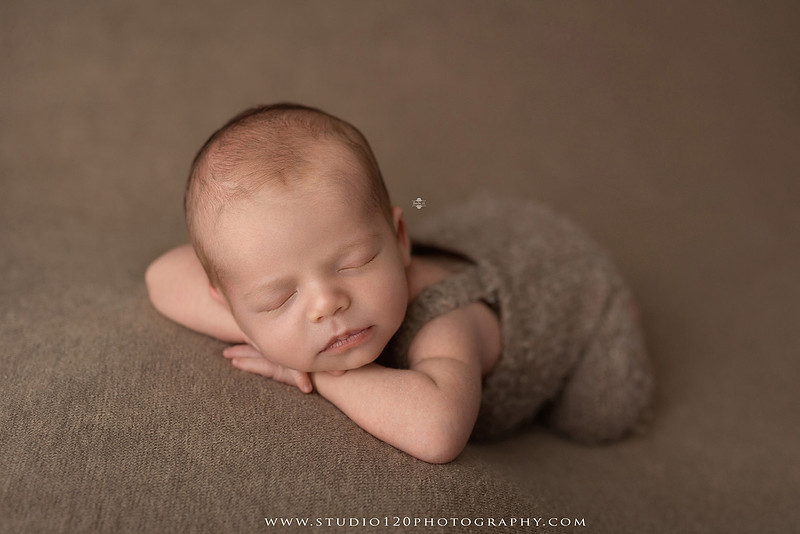 Professional newborn photography session featuring a sleeping baby boy in rustic western-inspired setups with cowboy hats, neutral wraps, wooden props, greenery, and vintage accents, along with heartfelt family portraits with parents and their dogs at Studio 120 Photography in Ramona, California.