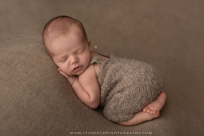 Professional newborn photography session featuring a sleeping baby boy in rustic western-inspired setups with cowboy hats, neutral wraps, wooden props, greenery, and vintage accents, along with heartfelt family portraits with parents and their dogs at Studio 120 Photography in Ramona, California.