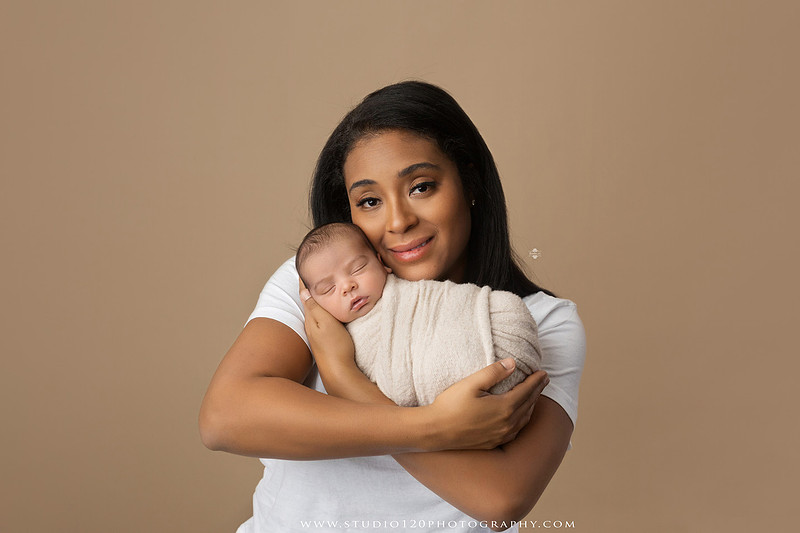 A professional newborn photography gallery featuring baby Caleb with his family at Studio 120 Photography in Ramona. The collection includes timeless family portraits with parents and four siblings, heartfelt individual parent and baby portraits, sibling photos gathered around a miniature crib, classic wrapped newborn poses, a personalized knit nightcap embroidered with Caleb's name, a custom football-themed newborn setup on a football under stadium lights, a football bowl prop with vintage football décor, and an organic newborn portrait with rich green knit textures and natural greenery. Soft neutral tones, personalized details, and family-centered images celebrate the arrival of a new baby while serving families throughout Ramona and the San Diego area.