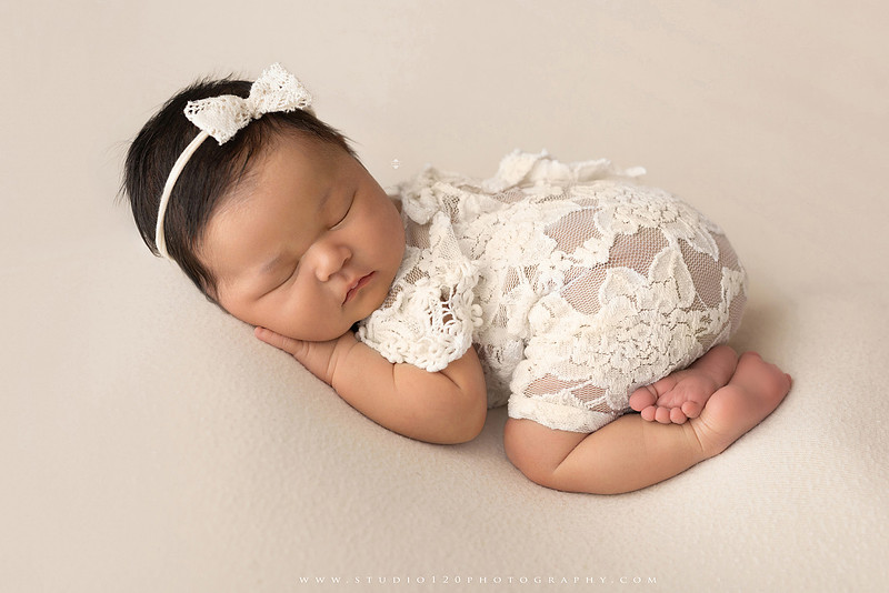 A collection of newborn baby girl portraits featuring peaceful sleeping poses, soft neutral wraps, delicate floral headbands, textured blankets, rustic baskets, natural wood props, creamy backdrops, and a special police tribute setup with a badge and Thin Blue Line flag. The gallery showcases timeless, baby-led newborn photography with warm, organic tones at Studio 120 Photography in Ramona, serving San Diego County.