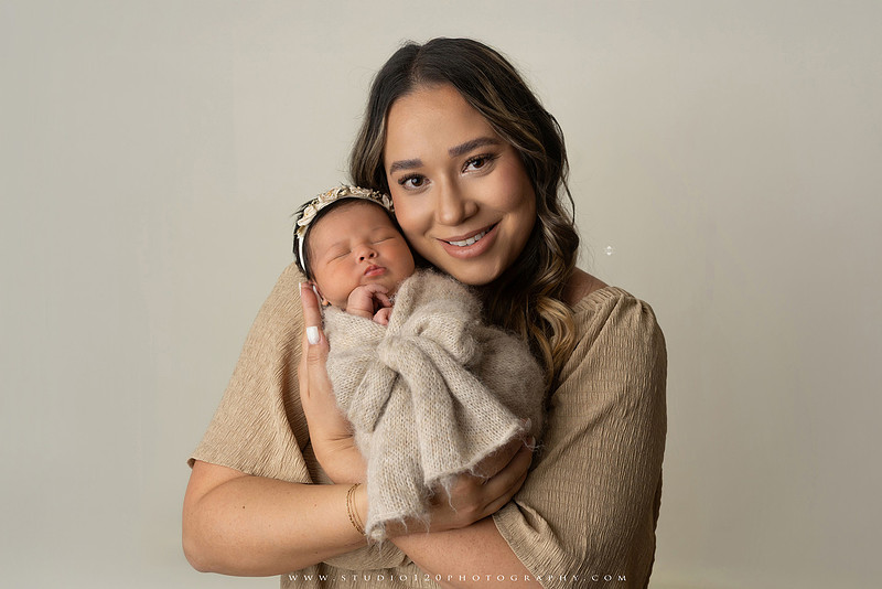 Timeless family newborn portraits featuring parents, siblings, and their new baby girl in soft neutral tones. The gallery includes standing family portraits, overhead sibling and newborn portraits, and natural moments celebrating the love, connection, and joy of welcoming a new baby. Captured at Studio 120 Photography in Ramona, serving San Diego County.