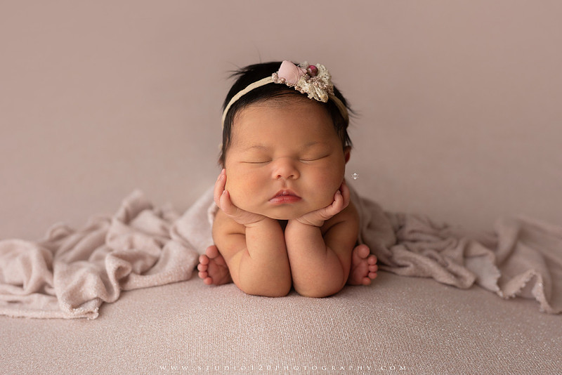 A collection of newborn baby girl portraits featuring peaceful sleeping poses, soft neutral wraps, delicate floral headbands, textured blankets, rustic baskets, natural wood props, creamy backdrops, and a special police tribute setup with a badge and Thin Blue Line flag. The gallery showcases timeless, baby-led newborn photography with warm, organic tones at Studio 120 Photography in Ramona, serving San Diego County.