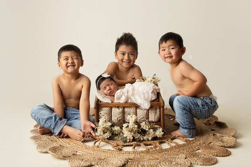Newborn photography session at Studio 120 Photography in Ramona, California, featuring a baby girl in soft pink, cream, floral and neutral setups, custom portraits with her mother’s Labubu doll collection, sibling photos with her three big brothers, family portraits with Mom and Dad, and timeless baby-only images.