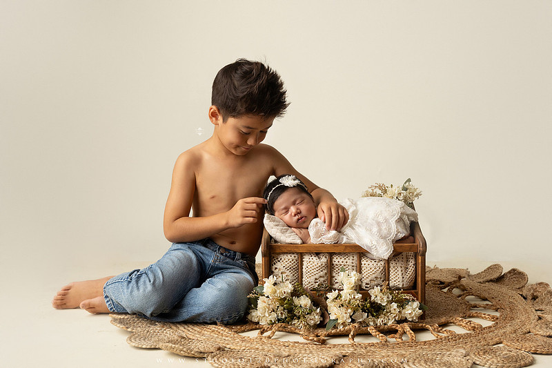 Newborn photography session at Studio 120 Photography in Ramona, California, featuring a baby girl in soft pink, cream, floral and neutral setups, custom portraits with her mother’s Labubu doll collection, sibling photos with her three big brothers, family portraits with Mom and Dad, and timeless baby-only images.