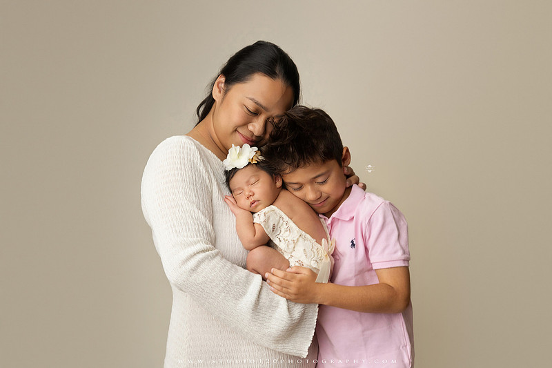 Newborn photography session at Studio 120 Photography in Ramona, California, featuring a baby girl in soft pink, cream, floral and neutral setups, custom portraits with her mother’s Labubu doll collection, sibling photos with her three big brothers, family portraits with Mom and Dad, and timeless baby-only images.