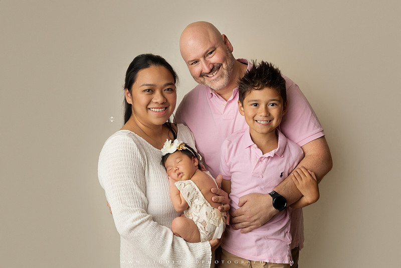Newborn photography session at Studio 120 Photography in Ramona, California, featuring a baby girl in soft pink, cream, floral and neutral setups, custom portraits with her mother’s Labubu doll collection, sibling photos with her three big brothers, family portraits with Mom and Dad, and timeless baby-only images.