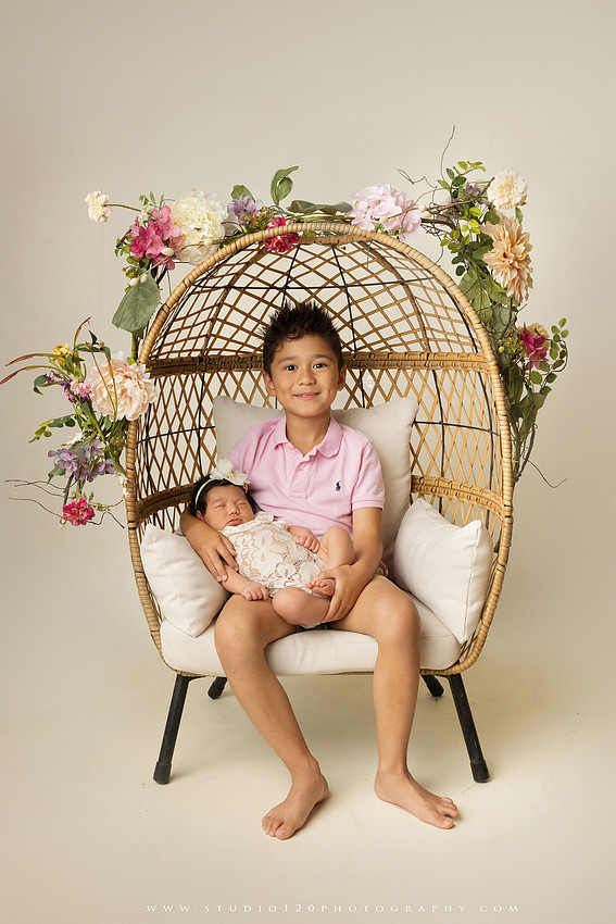 Newborn photography session at Studio 120 Photography in Ramona, California, featuring a baby girl in soft pink, cream, floral and neutral setups, custom portraits with her mother’s Labubu doll collection, sibling photos with her three big brothers, family portraits with Mom and Dad, and timeless baby-only images.