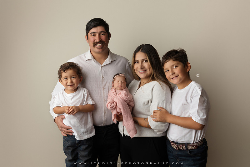 Newborn baby girl photography session featuring soft pink, lavender, blue and neutral styling, floral newborn portraits, rustic western-inspired setups, sibling photos with two big brothers, and family portraits with parents at Studio 120 Photography in Ramona, California.