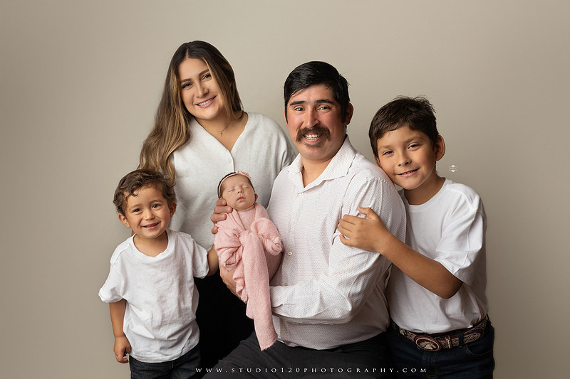 Newborn baby girl photography session featuring soft pink, lavender, blue and neutral styling, floral newborn portraits, rustic western-inspired setups, sibling photos with two big brothers, and family portraits with parents at Studio 120 Photography in Ramona, California.