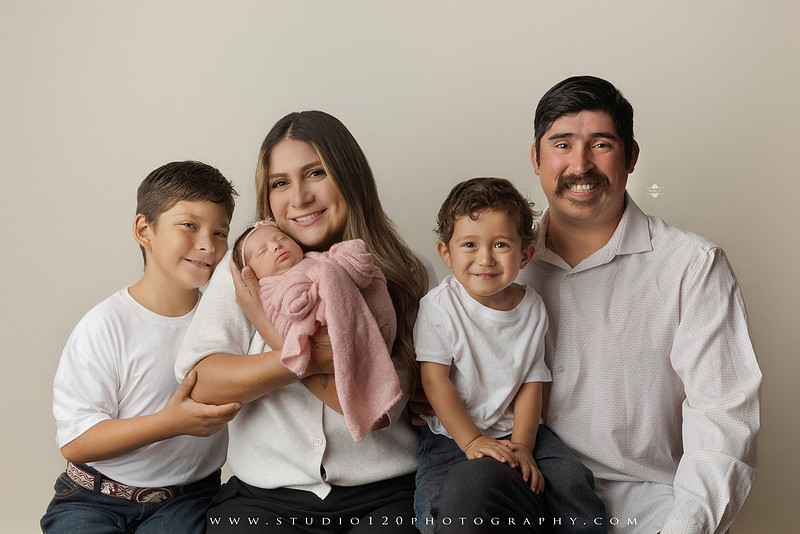 Newborn baby girl photography session featuring soft pink, lavender, blue and neutral styling, floral newborn portraits, rustic western-inspired setups, sibling photos with two big brothers, and family portraits with parents at Studio 120 Photography in Ramona, California.