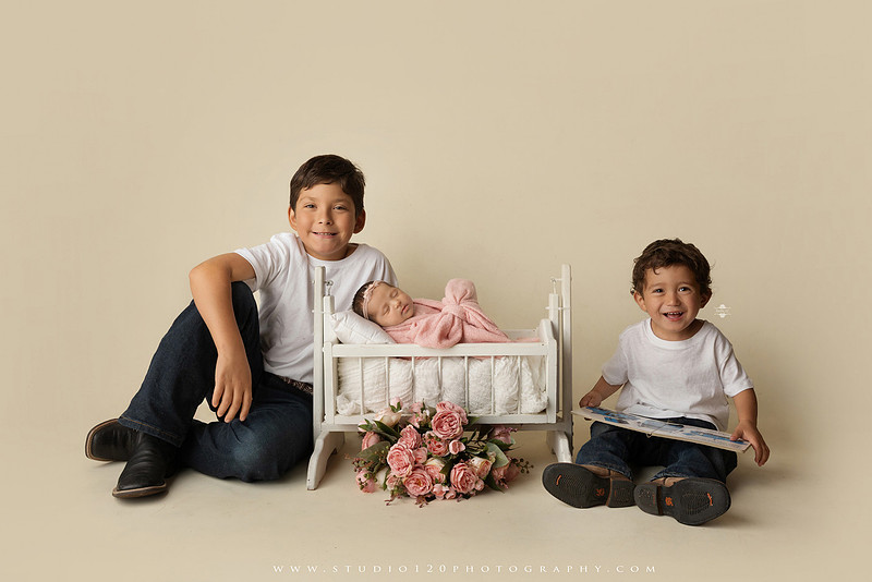 Newborn baby girl photography session featuring soft pink, lavender, blue and neutral styling, floral newborn portraits, rustic western-inspired setups, sibling photos with two big brothers, and family portraits with parents at Studio 120 Photography in Ramona, California.