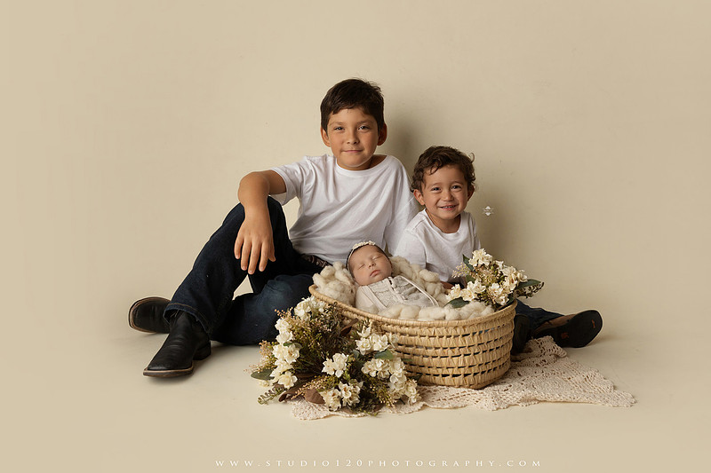 Newborn baby girl photography session featuring soft pink, lavender, blue and neutral styling, floral newborn portraits, rustic western-inspired setups, sibling photos with two big brothers, and family portraits with parents at Studio 120 Photography in Ramona, California.